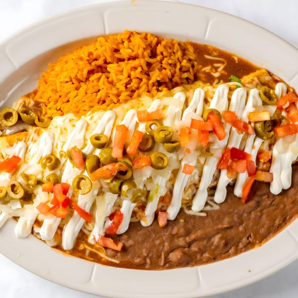Si Senor Mexican Restaurant's enchiladas with rice, refried beans, sour cream, olives, and diced tomatoes.