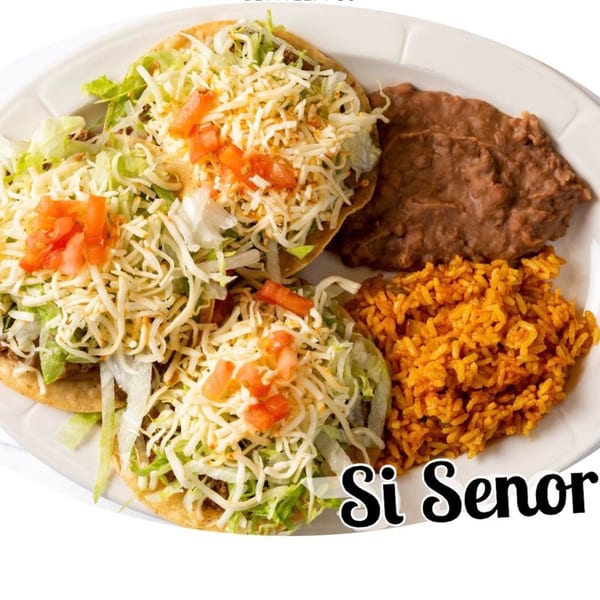 Two Si Senor Mexican tostadas with lettuce, cheese, and tomatoes, served with rice and refried beans.